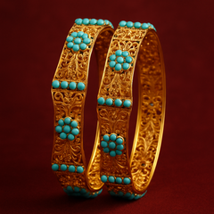 Gold bangles with turquoise stones on a red background