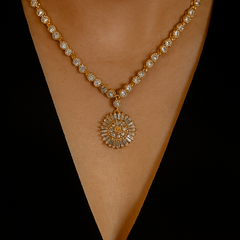 Gold necklace with a heart-shaped pendant on a black background