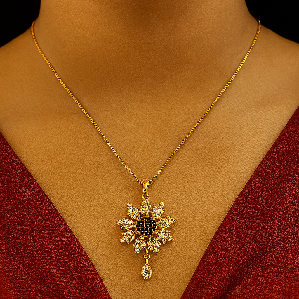 Gold necklace with a diamond pendant on a person wearing a red garment.