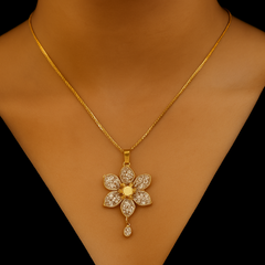 Gold necklace with a floral pendant on a mannequin