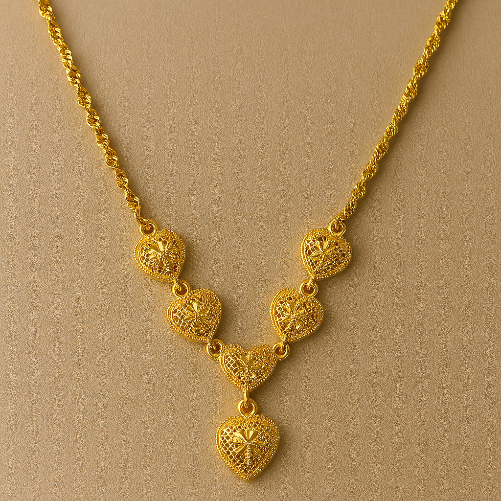 Gold necklace with heart-shaped pendants on a beige background